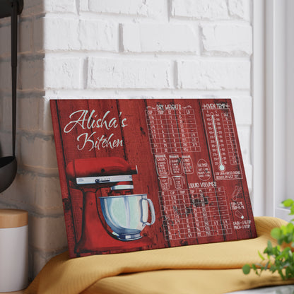 Personalized glass cutting board featuring a red stand mixer illustration, kitchen measurement and oven temperature conversion charts, and custom name displayed on a kitchen counter.