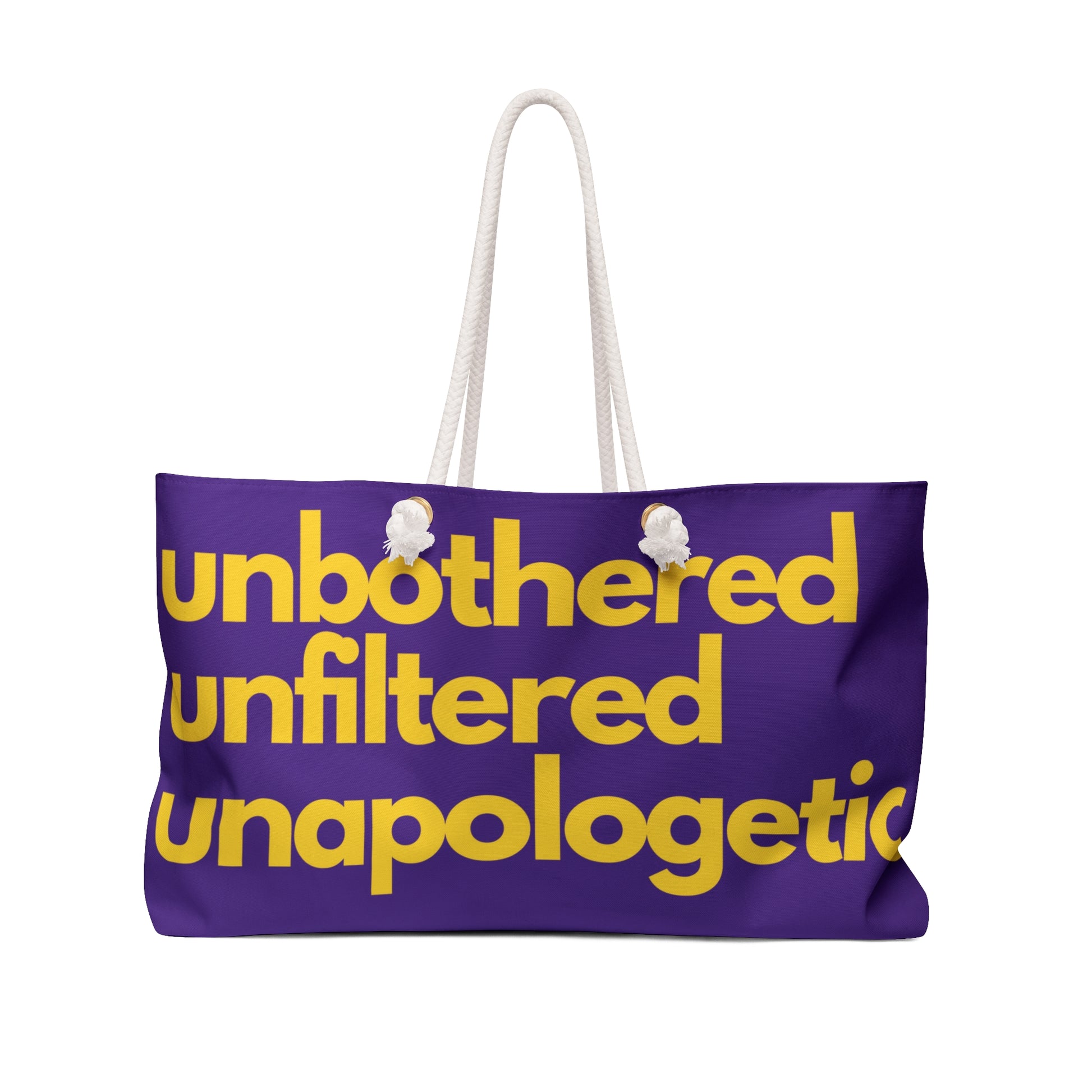 Purple weekender bag with rope handles featuring the phrase “Unbothered Unfiltered Unapologetic” in bold gold lettering.